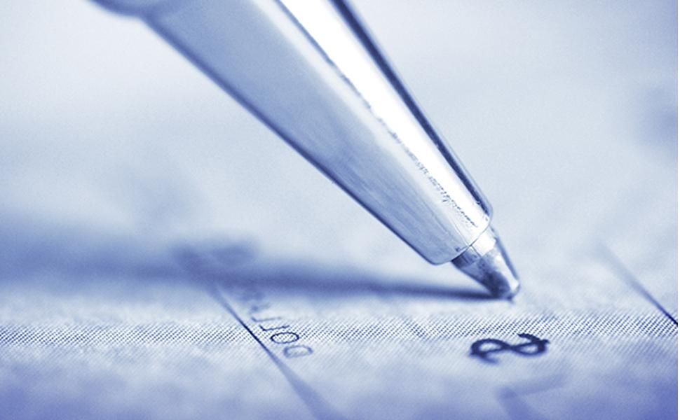 An image of a pen signing a check